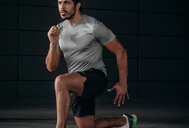 man in white crew neck t-shirt and black shorts sitting on floor